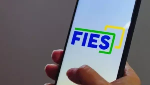 moça segurando celular com app do fies
